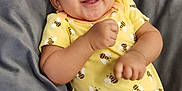 Trinity joined the competition — help win amazing prizes! baby, bee_pattern, child, comfortable, cushion, cute, face, gray_fabric, hand, happy, head, indoors, infant, person, portrait, relaxed, skin, smiling, yellow_onesie, young
