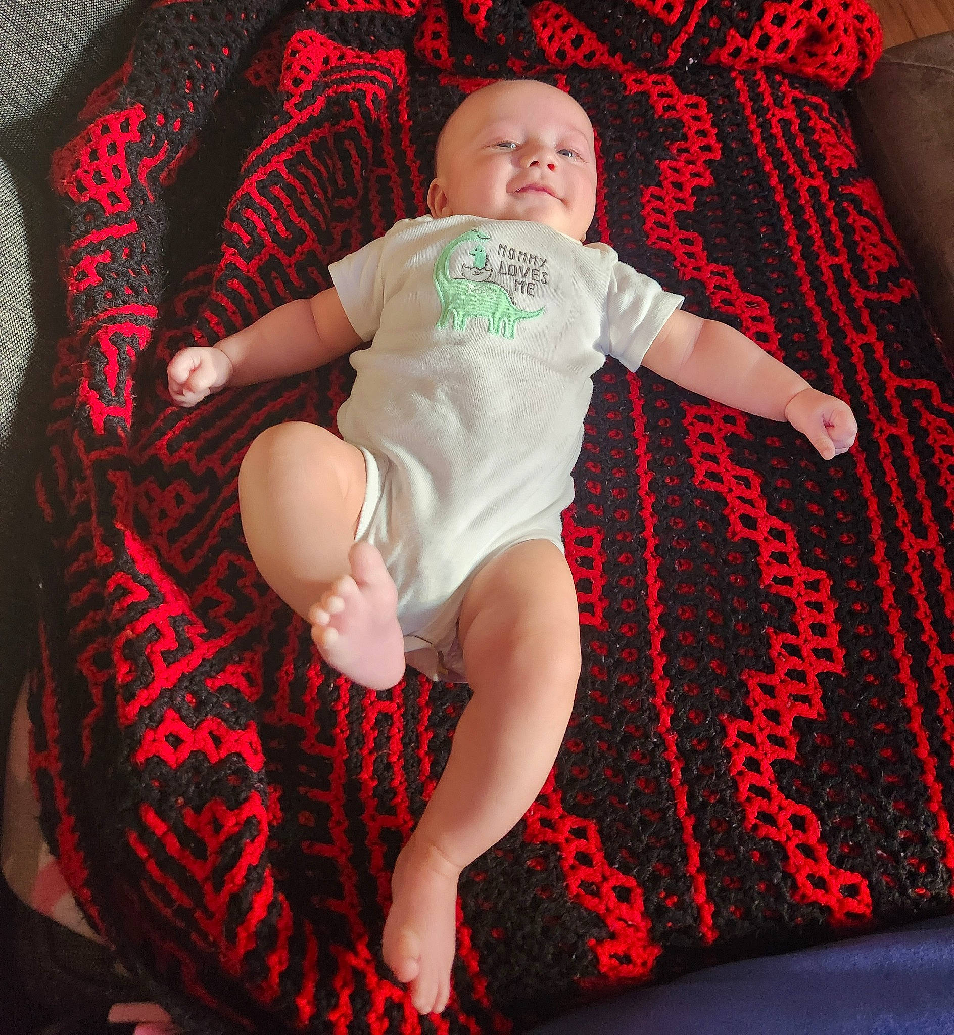 Kayden is registered to the contest to win money with this photo: baby, baby_toddler_clothing, carmine, child, comfort, finger, flash_photography, fun, happy, human_leg, knee, leg, magenta, pattern, person, pink, sitting, sleeve, t_shirt, thigh