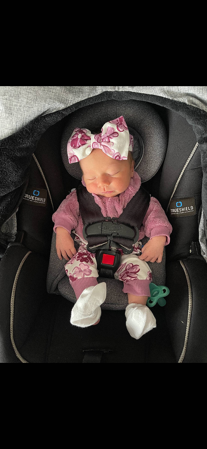 Adrian is registered to the contest to win money with this photo: auto_part, baby, baby_carriage, baby_in_car_seat, baby_products, baby_safety, baby_sleeping, baby_toddler_clothing, car_seat, cheek, comfort, headwear, lap, magenta, outerwear, person, personal_protective_equipment, pink, seat_belt, sitting