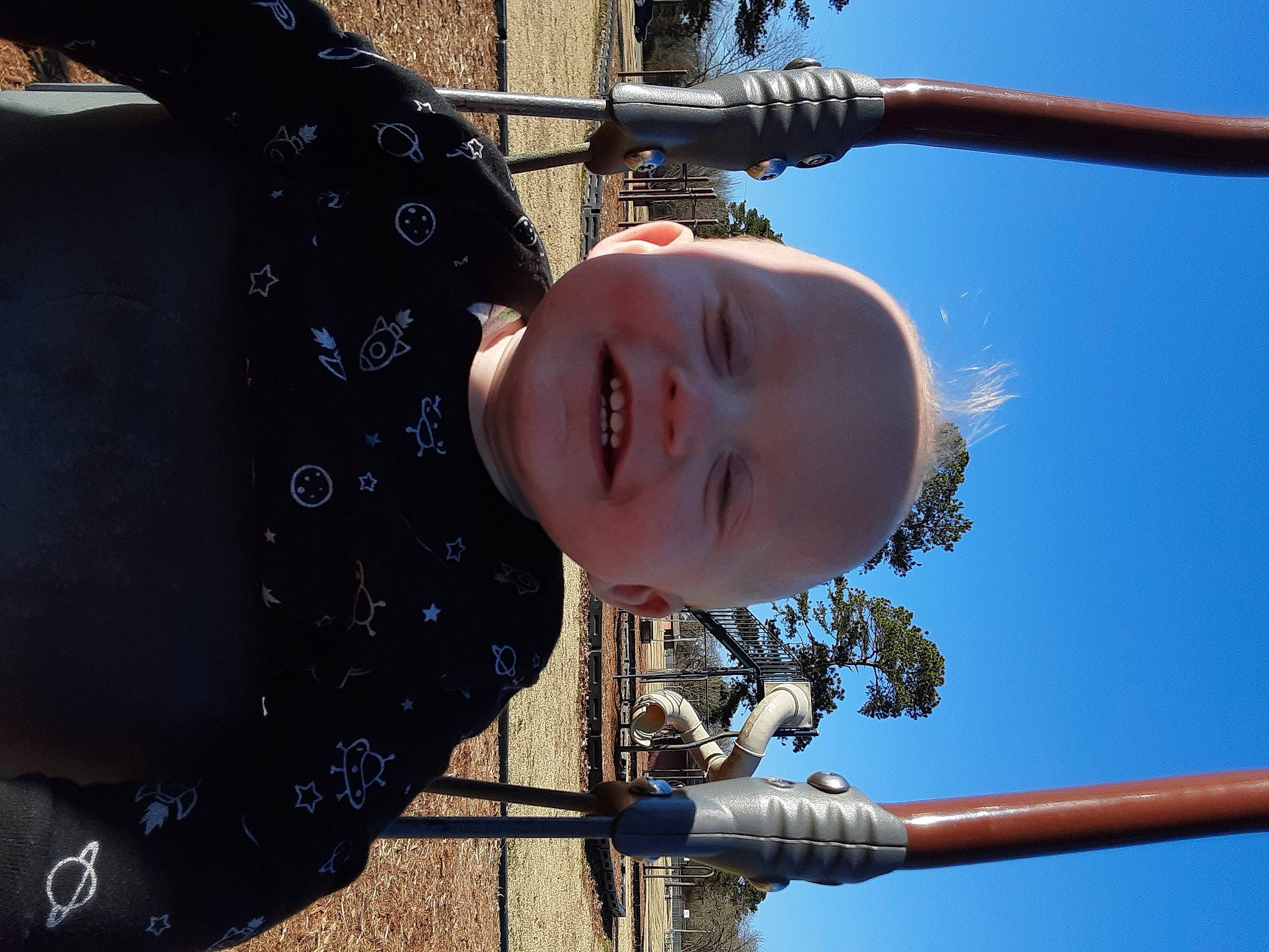 Blaine is registered to the contest to win money with this photo: city, daytime, electric_blue, fun, happy, leisure, light, line, outdoor_play_equipment, person, photograph, playground, public_space, recreation, sky, smile, snapshot, toddler, water, white