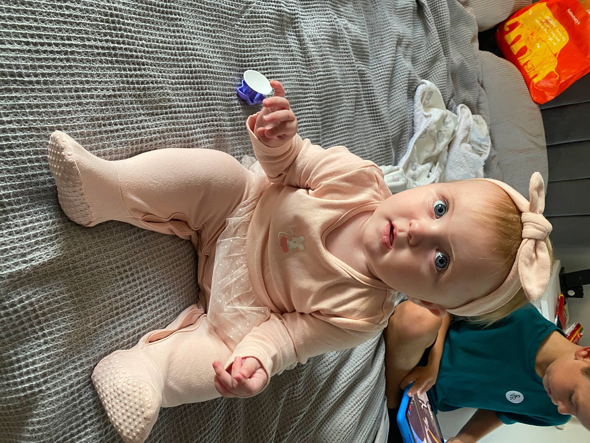 Macy is registered to the contest to win money with this photo: arm, baby, barechested, chest, child, comfort, facial_expression, flesh, foot, fun, gesture, hand, happy, mouth, person, room, skin, smile, thigh, thumb