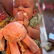 Layla is registered to the contest to win money with this photo: baby, child, plush_toy, stuffed_animal, pink, bunny, holding, cute, person, infant, soft_toy, hand, face, indoor, blurred_background, patterned_clothing, adorable, closeup, toddler, comfort