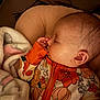 Layla is registered to the contest to win money with this photo: baby, sleeping, blanket, hand, face, ear, clothing, pattern, floral, orange, comfort, bedtime, cute, child, infant, cozy, portrait, peaceful, sleeve, closeup