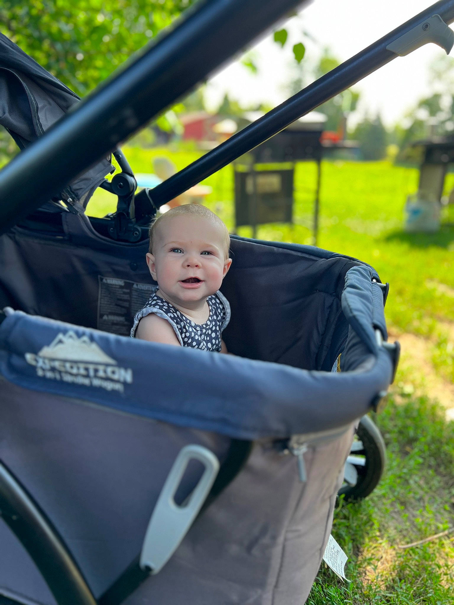 Emilia is registered to the contest to win money with this photo: auto_part, automotive_design, automotive_exterior, automotive_tire, automotive_wheel_system, baby, baby_carriage, hand, helmet, leisure, mode_of_transport, motor_vehicle, person, plant, recreation, rim, tire, toddler, tree, vehicle