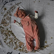 Malia participe au concours pour gagner de l'argent avec cette photo : baby, infant, pink_outfit, headband, blanket, crescent_moon, stars, lying_down, happy, smiling, soft_toy_design, cozy, child, cute, indoors, sleepwear, fabric, decor, portrait, newborn