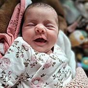 Malia participe au concours pour gagner de l'argent avec cette photo : baby, blanket, closeup, clothing, cozy, cute, face, floral_pattern, head, indoors, infant, newborn, peaceful, person, portrait, sleeping, smiling, soft, warm, wrapped
