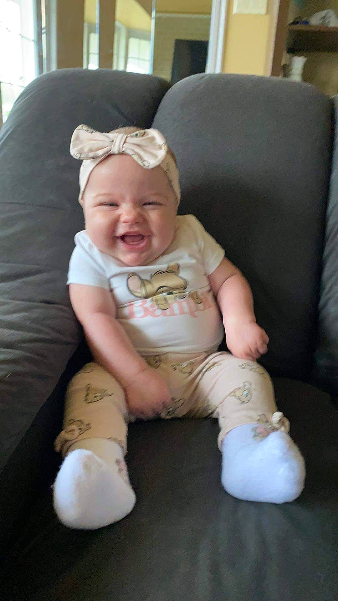 Hope-éléna Perreau participe au concours pour gagner de l'argent avec cette photo : baby, baby_toddler_clothing, cheek, child, comfort, couch, facial_expression, fun, grass, headwear, human_leg, knee, lap, person, sitting, skin, sleeve, smile, sock, textile