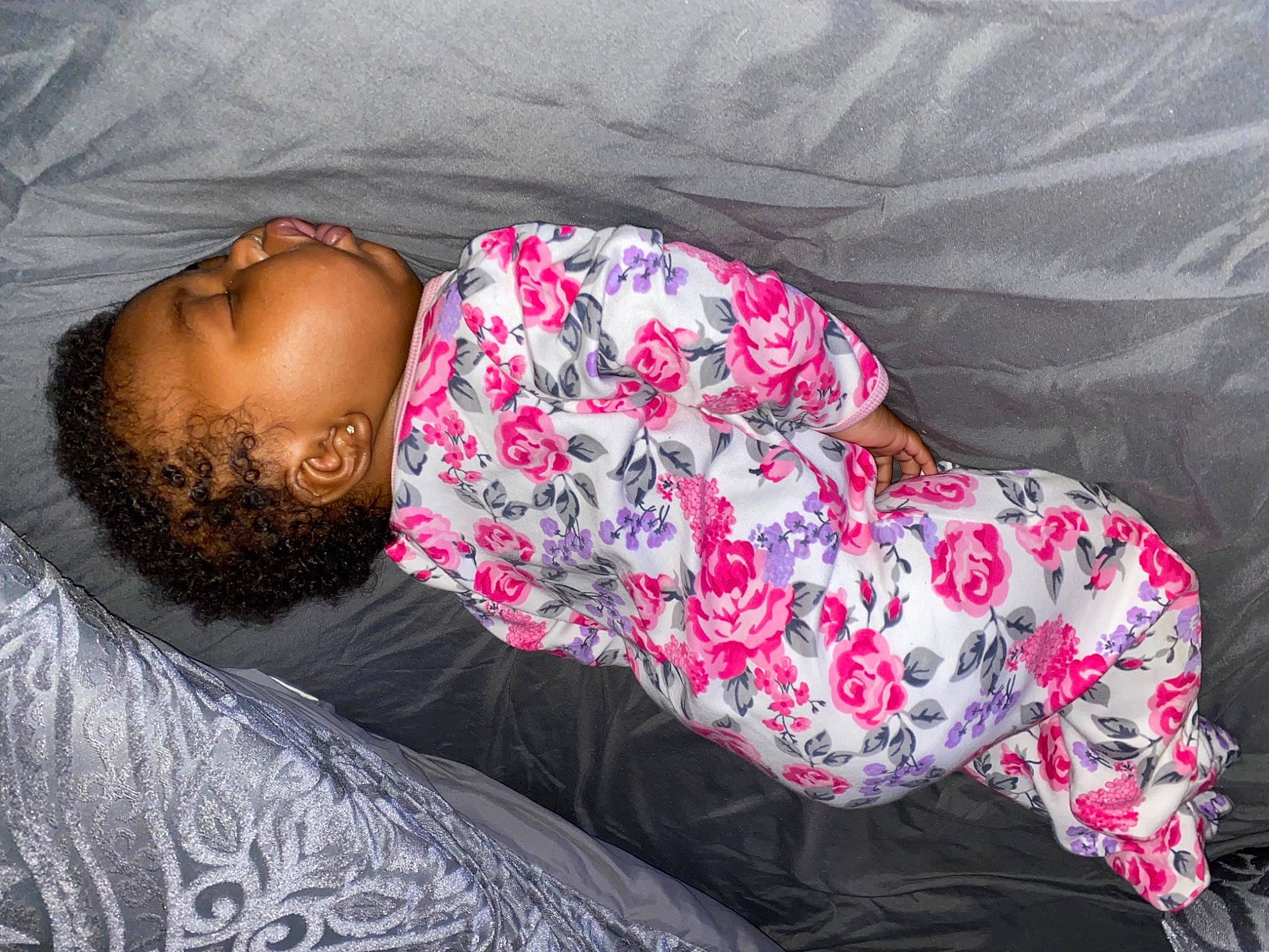 Anova is registered to the contest to win money with this photo: arm, beard, bedding, bedtime, comfort, couch, fur, grey, human_body, human_leg, linens, magenta, nap, pattern, person, pink, purple, sleeve, thigh, toddler