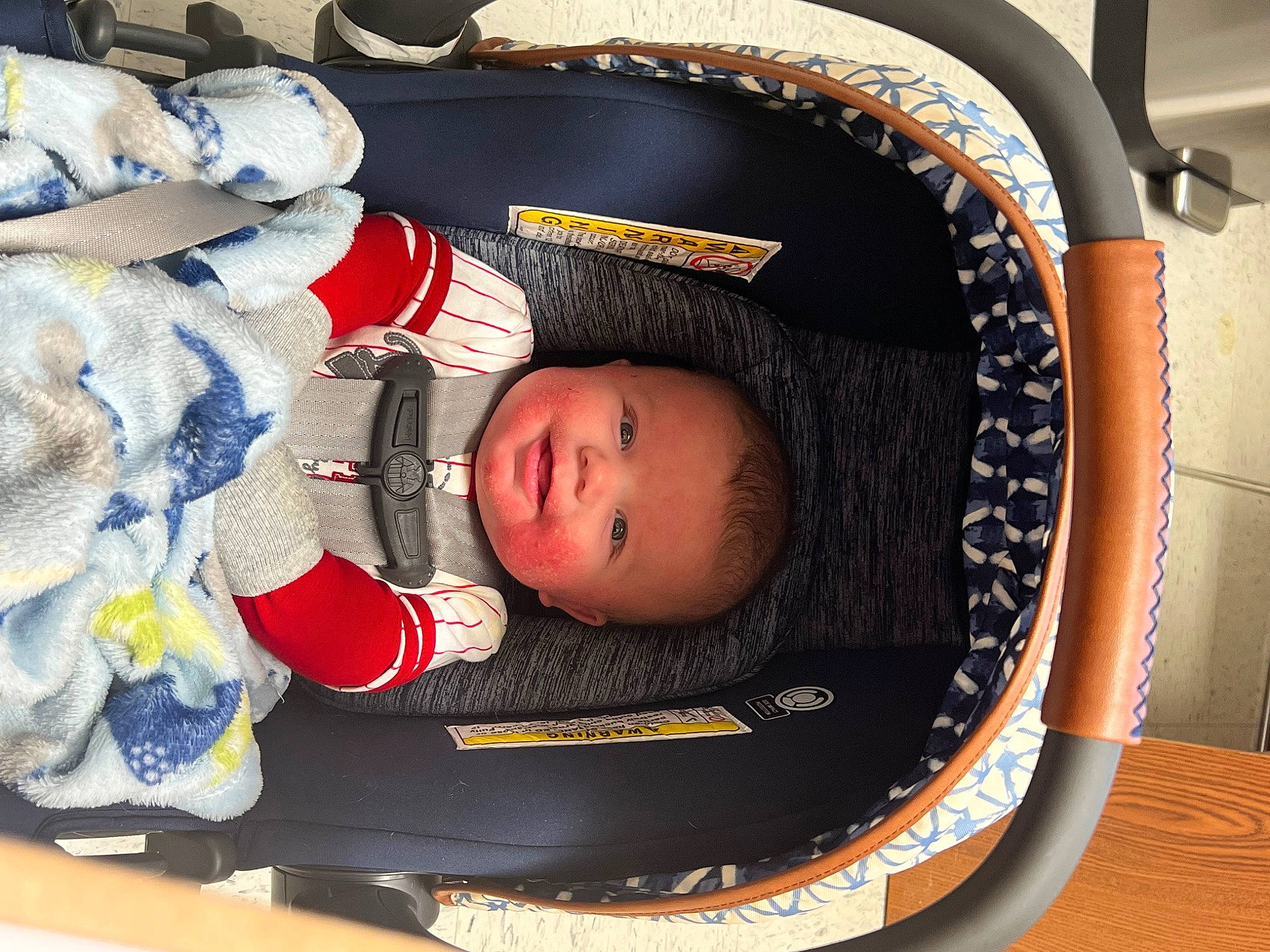Isaiah is registered to the contest to win money with this photo: baby, baby_carriage, baby_products, baby_safety, baby_sleeping, baby_toddler_clothing, baby_toys, car_seat, carmine, child, comfort, facial_expression, headgear, person, room, toddler