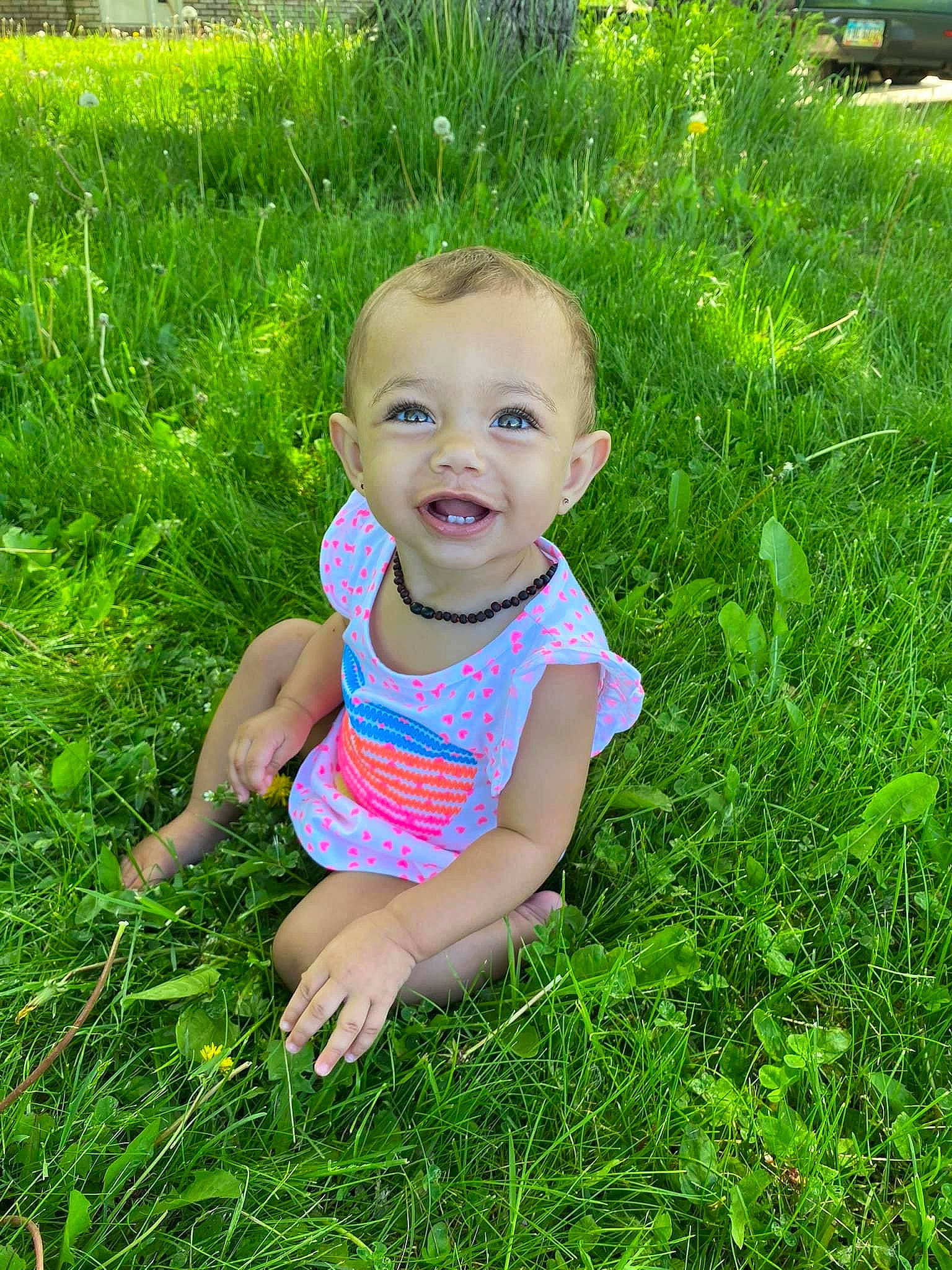 Kinzley is registered to the contest to win money with this photo: baby, baby_toddler_clothing, eye, grass, grass_family, grassland, green, groundcover, happy, head, landscape, leisure, meadow, people_in_nature, person, plant, skin, smile, t_shirt, terrestrial_plant