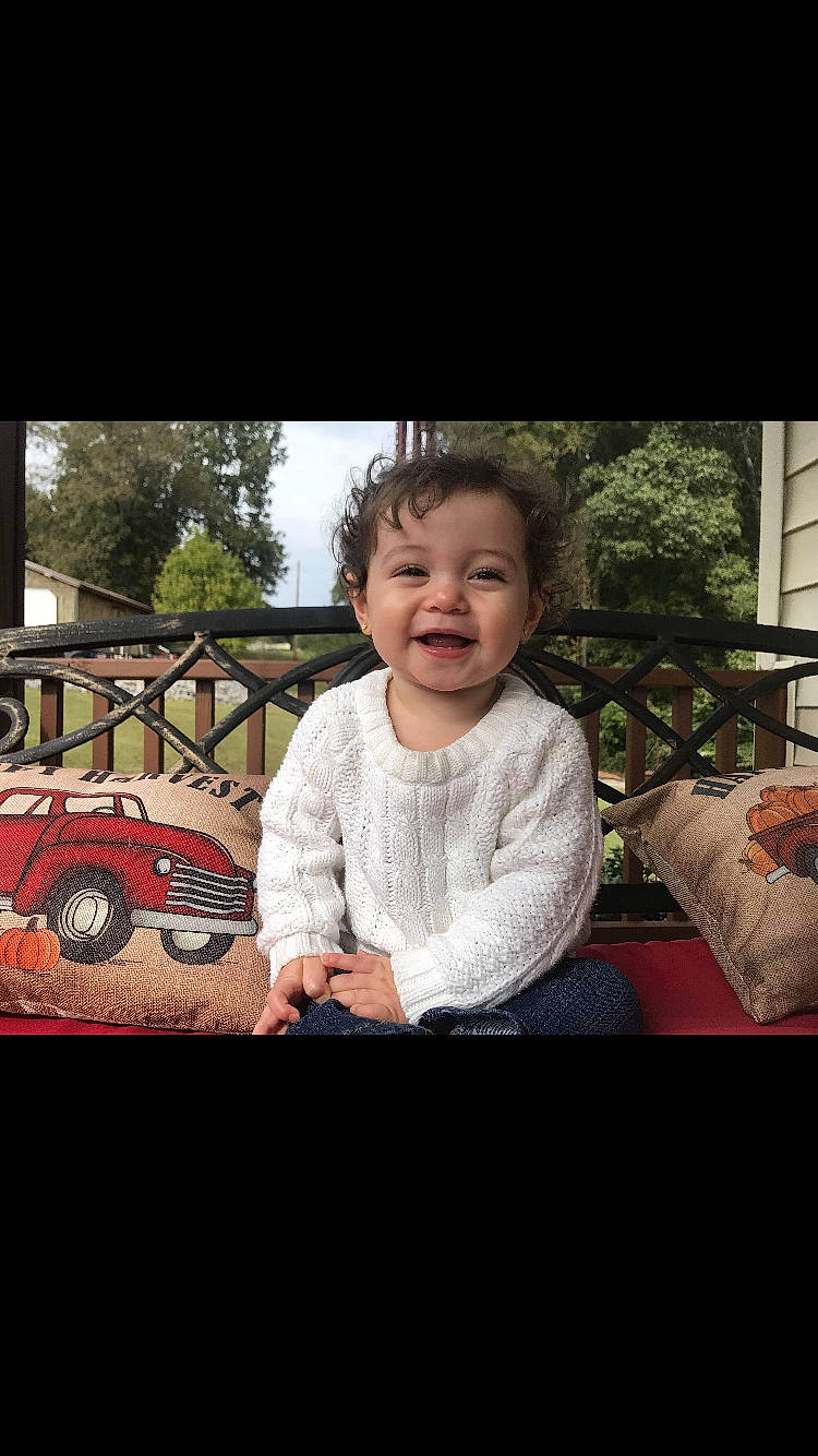 Anniston is registered to the contest to win money with this photo: cheek, child, cool, eye, face, facial_expression, happy, head, people, person, photo_caption, photography, play, sitting, smile, toddler