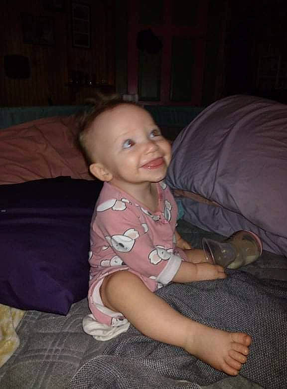 Phoenix joined the competition — help win amazing prizes! arm, cheek, chest, child, comfort, couch, finger, floor, flooring, fun, hardwood, head, joy, lap, leg, living_room, mouth, person, smile, toddler