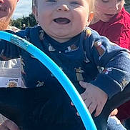 River is registered to the contest to win money with this photo: toddler, child, girl, man, dolphin, playground, outdoor, sky, blue_sky, smile, happy, toy, play, daylight, person, clothing, family, fun, nature, park