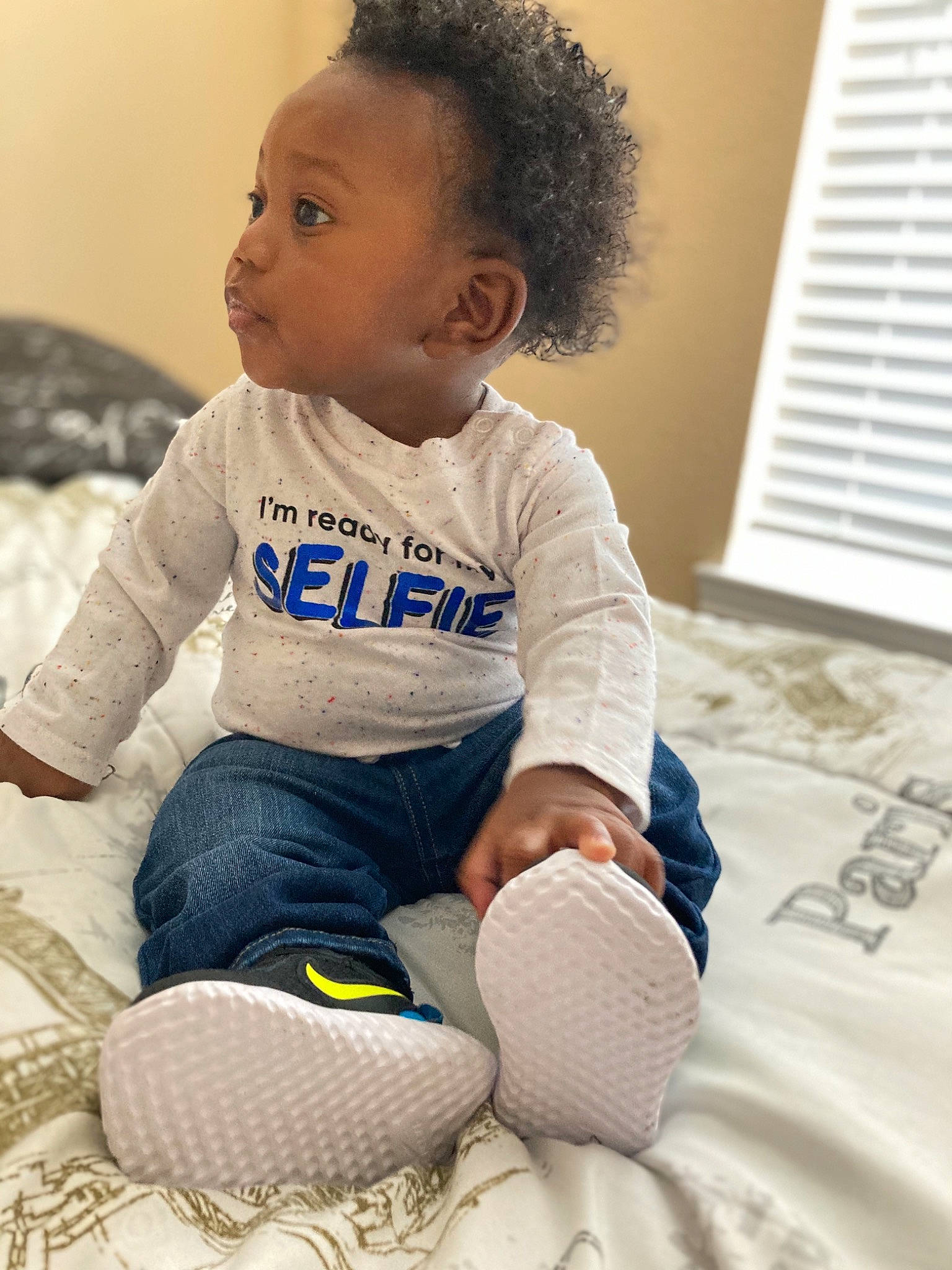 Javon joined the competition — help win amazing prizes! ankle, baby, baby_products, baby_toddler_clothing, ball, child, human_body, overall, person, sitting, sleeve, sock, toddler, walking_shoe, window_blind, window_covering