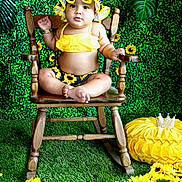Kaylani is registered to the contest to win money with this photo: baby, chair, clothing, daisy, face, flower, flowerarrangement, flowerbouquet, furniture, grass, hat, head, herbal, herbs, person, petal, photography, plant, portrait, sunflower