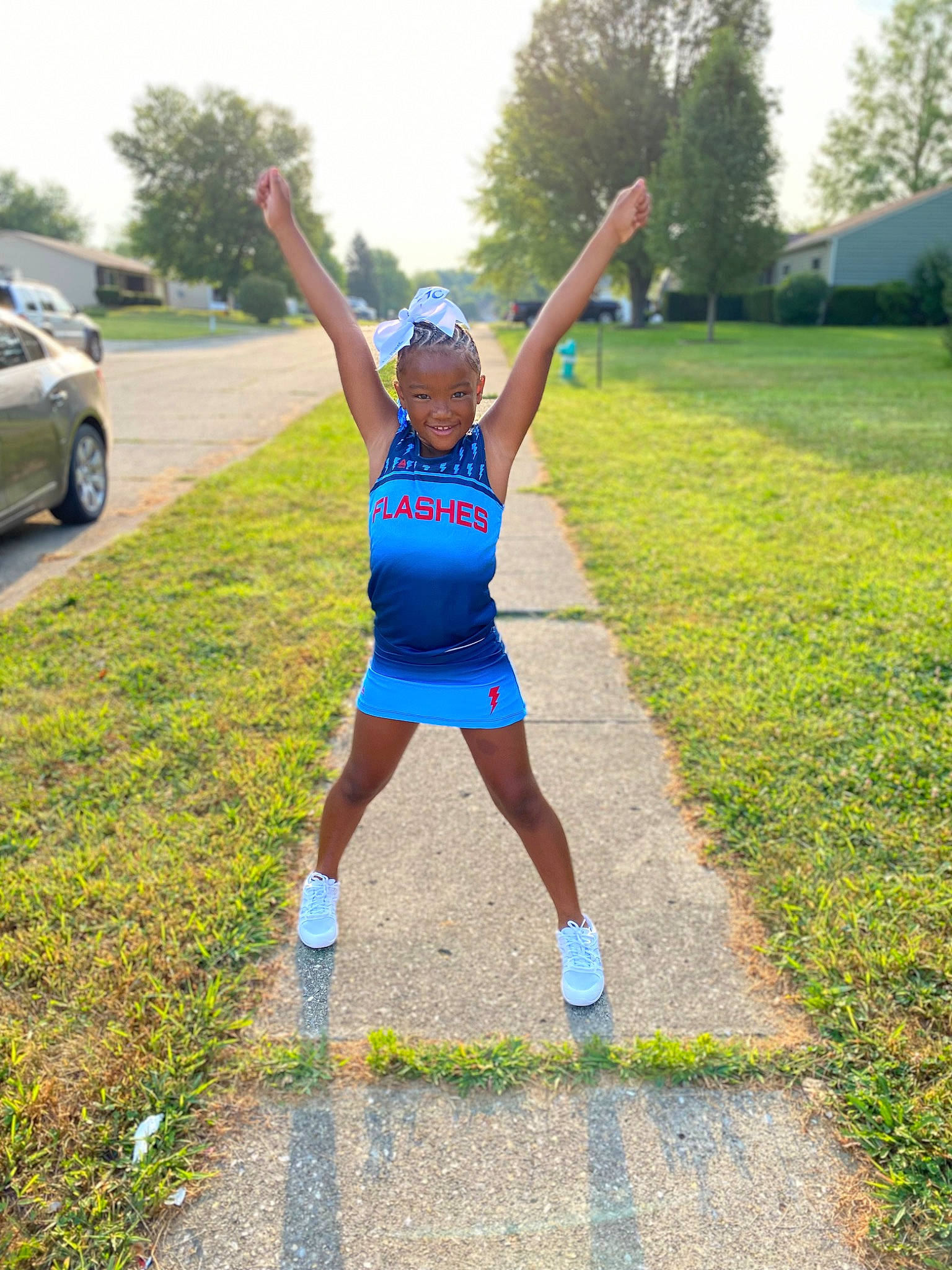 Adrienne is registered to the contest to win money with this photo: asphalt, athlete, exercise, grass, happy, joy, knee, leisure, outdoor_recreation, person, plant, recreation, road, shorts, sky, smile, sports_uniform, sportswear, thigh, tree