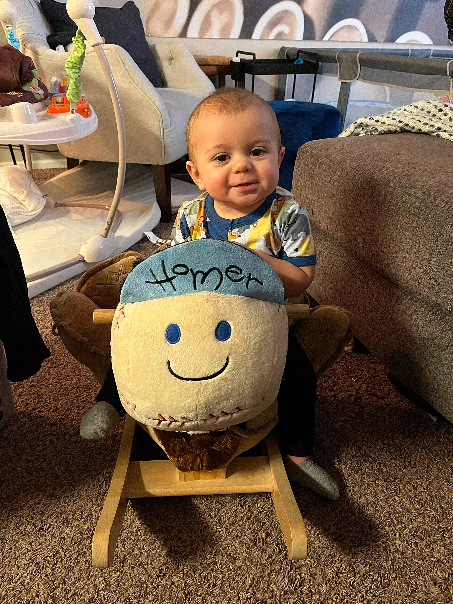 Kynstin is registered to the contest to win money with this photo: baby, chair, child, cool, event, eyewear, facial_expression, flooring, fun, furniture, happy, joy, people, person, shoe, sitting, smile, stuffed_toy, table, toddler