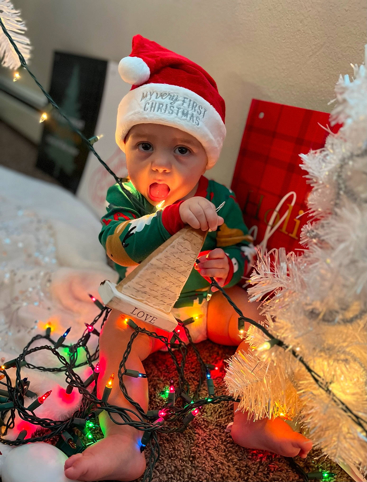 Kynstin joined the competition — help win amazing prizes! baby, baby_toddler_clothing, cap, child, christmas, christmas_decoration, christmas_ornament, costume_hat, event, fictional_character, happy, hat, headwear, holiday, lap, ornament, person, pink, santa_claus, thigh