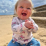 Victoria-Rose joined the competition — help win amazing prizes! baby, child, smiling, happy, sitting, beach, sand, cloudy_sky, stairs, pony_tail, minnie_mouse, clothing, denim_pants, cute, outdoor, portrait, person, joyful, playful, daytime
