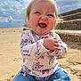 baby, child, smiling, happy, sitting, beach, sand, cloudy_sky, stairs, pony_tail, minnie_mouse, clothing, denim_pants, cute, outdoor, portrait, person, joyful, playful, daytime
