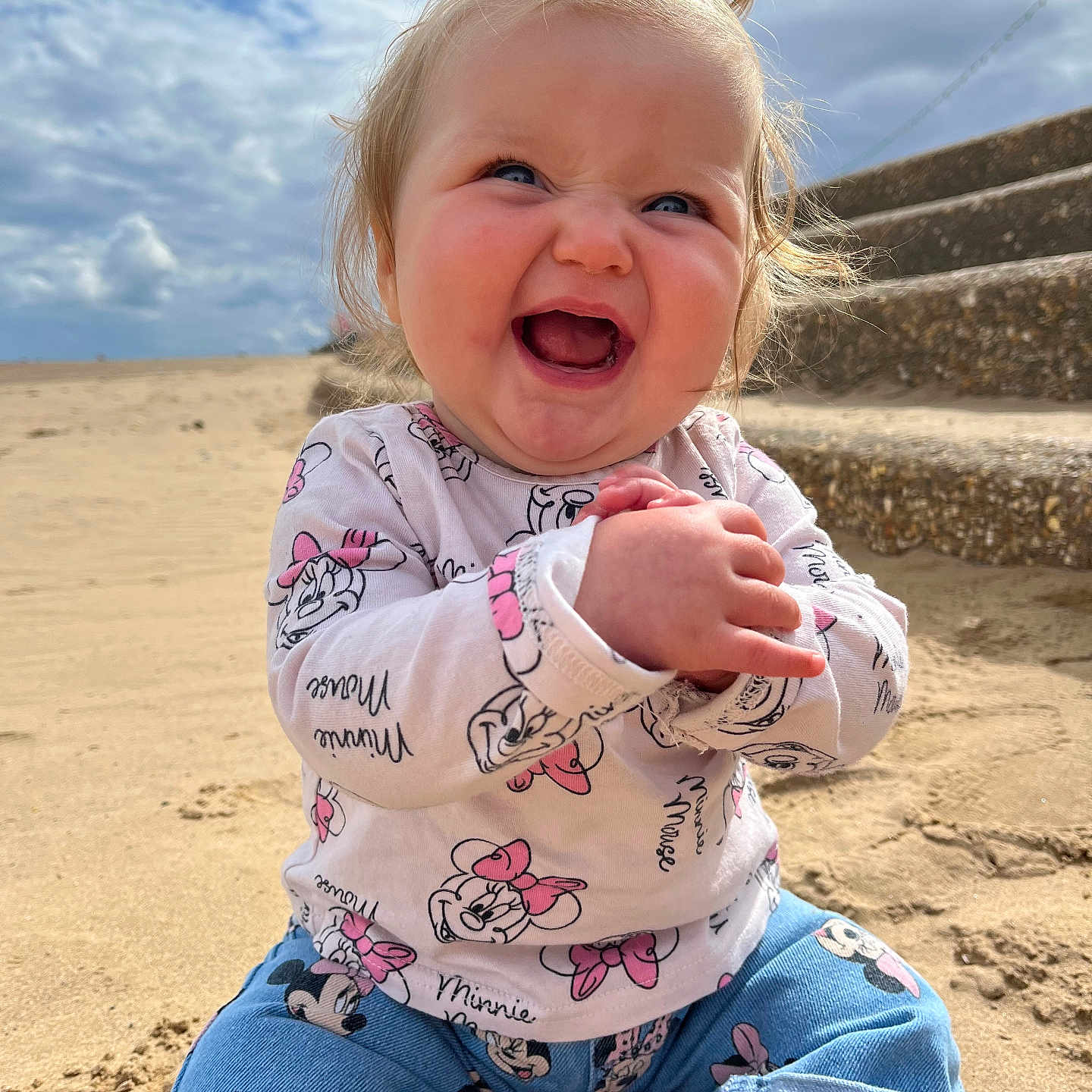 Victoria-Rose joined the competition — help win amazing prizes! baby, beach, child, clothing, cloudy_sky, cute, daytime, denim_pants, happy, joyful, minnie_mouse, outdoor, person, playful, pony_tail, portrait, sand, sitting, smiling, stairs