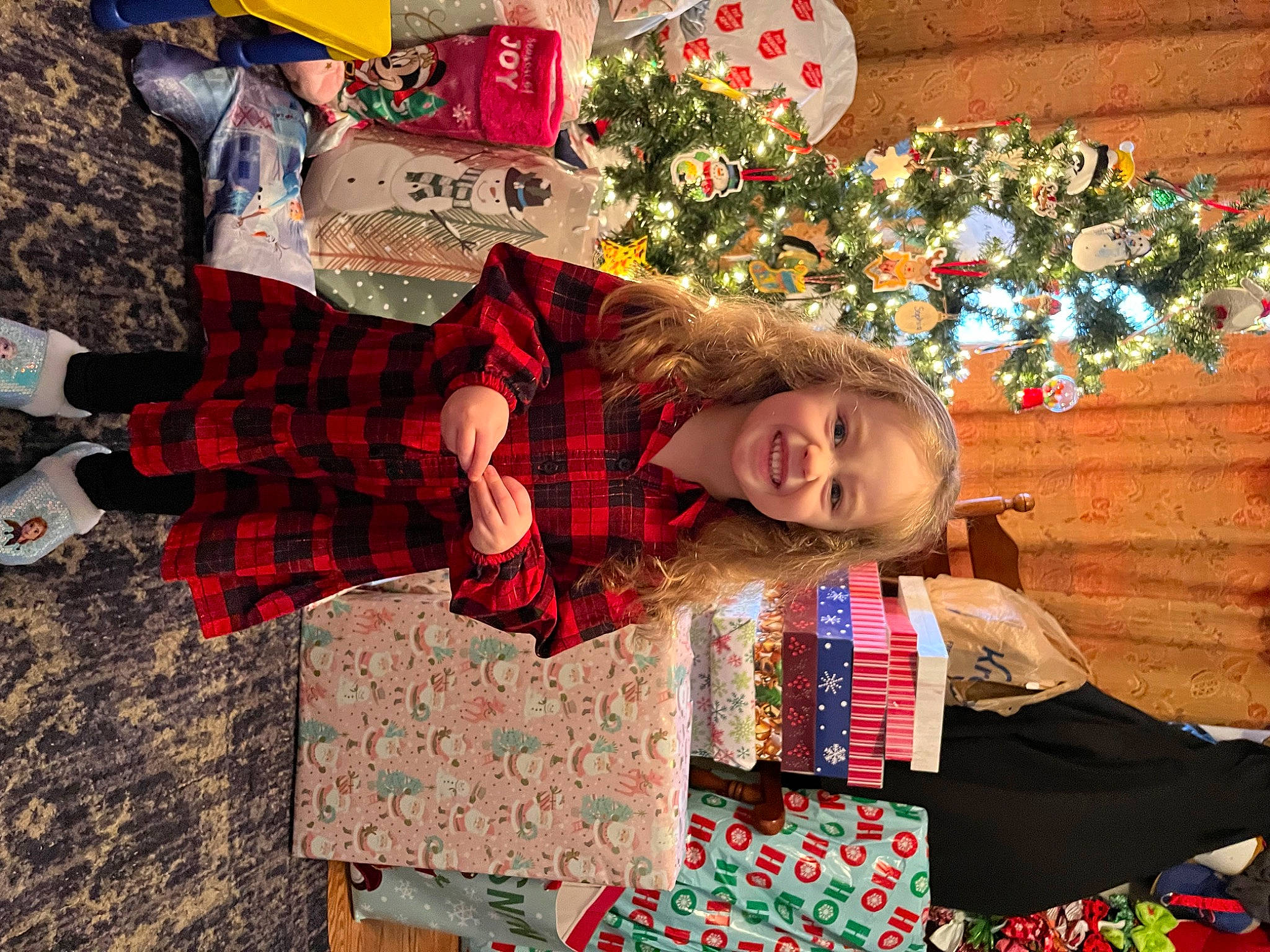 Kylie joined the competition — help win amazing prizes! child, christmas, christmas_decoration, christmas_eve, christmas_ornament, event, fun, happy, holiday, joy, leisure, pattern, person, plaid, red, sitting, smile, tartan, tradition, travel