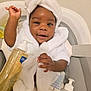 baby, infant, towel, white_towel, baby_bath, bath_seat, mustela, baby_skincare, smiling, happy, child, cute, skin, moisturizer, cream, bottle, baby_clothing, indoors, person, baby_care