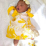 Olakamiye joined the competition — help win amazing prizes! baby, infant, sleeping, yellow_dress, headband, bow, blanket, soft_texture, footwear, golden_shoes, white_background, cute, peaceful, lying_down, newborn, child, indoors, fashion, adorable, portrait