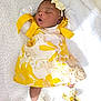 baby, infant, sleeping, yellow_dress, headband, bow, blanket, soft_texture, footwear, golden_shoes, white_background, cute, peaceful, lying_down, newborn, child, indoors, fashion, adorable, portrait