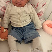 Tiyana participe au concours pour gagner de l'argent avec cette photo : baby, chair, child, clothing, cozy, cushion, cute, denim_shorts, happy, indoor, infant, person, pink_bows, portrait, seated, shoes, smile, soft_lighting, tights, white_cardigan