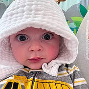 Oden joined the competition — help win amazing prizes! baby, child, hood, white, striped_clothing, yellow, construction_truck, face, eyes, cute, infant, portrait, expression, indoor, colorful_background, cartoon_animals, curious, closeup, clothing, soft_texture