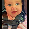 Bailey Baize is registered to the contest to win money with this photo: baby, child, infant, smiling, happy, portrait, car_seat, safety_harness, seatbelt, vehicle, pink_clothing, eyes, face, indoor, close_up, sitting, photograph, morning, timestamp, black_background