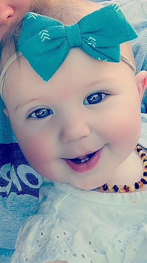 Paisley is registered to the contest to win money with this photo: azure, baby_toddler_clothing, blue, cap, cheek, chin, eyebrow, facial_expression, hairstyle, happy, headwear, iris, lip, organ, person, photograph, pink, purple, skin, sleeve