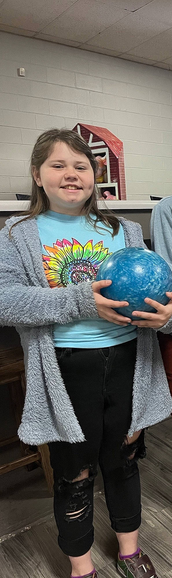 Rileigh is registered to the contest to win money with this photo: ball, child, community, event, fun, happy, human, jewellery, joy, leisure, necklace, organ, pattern, person, recreation, shoulder, smile, social_group, standing, t_shirt