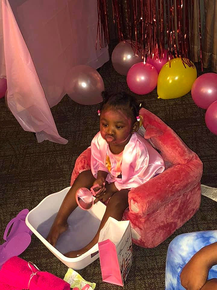 Jakayla joined the competition — help win amazing prizes! balloon, blue, event, fun, happy, human_leg, lap, leisure, lighting, magenta, organ, party, party_supply, person, pink, recreation, sitting, smile, thigh, toddler