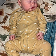 Jaxsyn joined the competition — help win amazing prizes! baby, sleeping, onesie, yellow_clothing, infant, cushion, animal_print, deer, pine_tree, bedtime, sleepwear, child, indoors, peaceful, resting, face, hand, footed_pajamas, blanket, comfort
