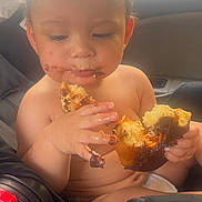 Adrian joined the competition — help win amazing prizes! toddler, child, car_seat, chocolate, pastry, messy, food, face, hands, indoor, seatbelt, hair, skin, eating, cute, baby, snack, closeup, seat, window