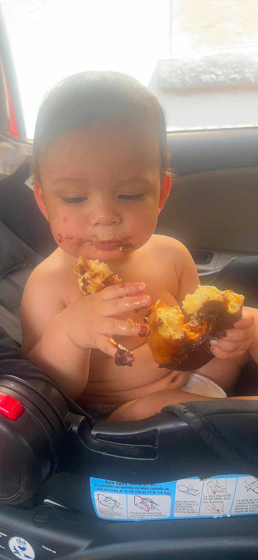 Adrian joined the competition — help win amazing prizes! toddler, child, car_seat, chocolate, pastry, messy, food, face, hands, indoor, seatbelt, hair, skin, eating, cute, baby, snack, closeup, seat, window