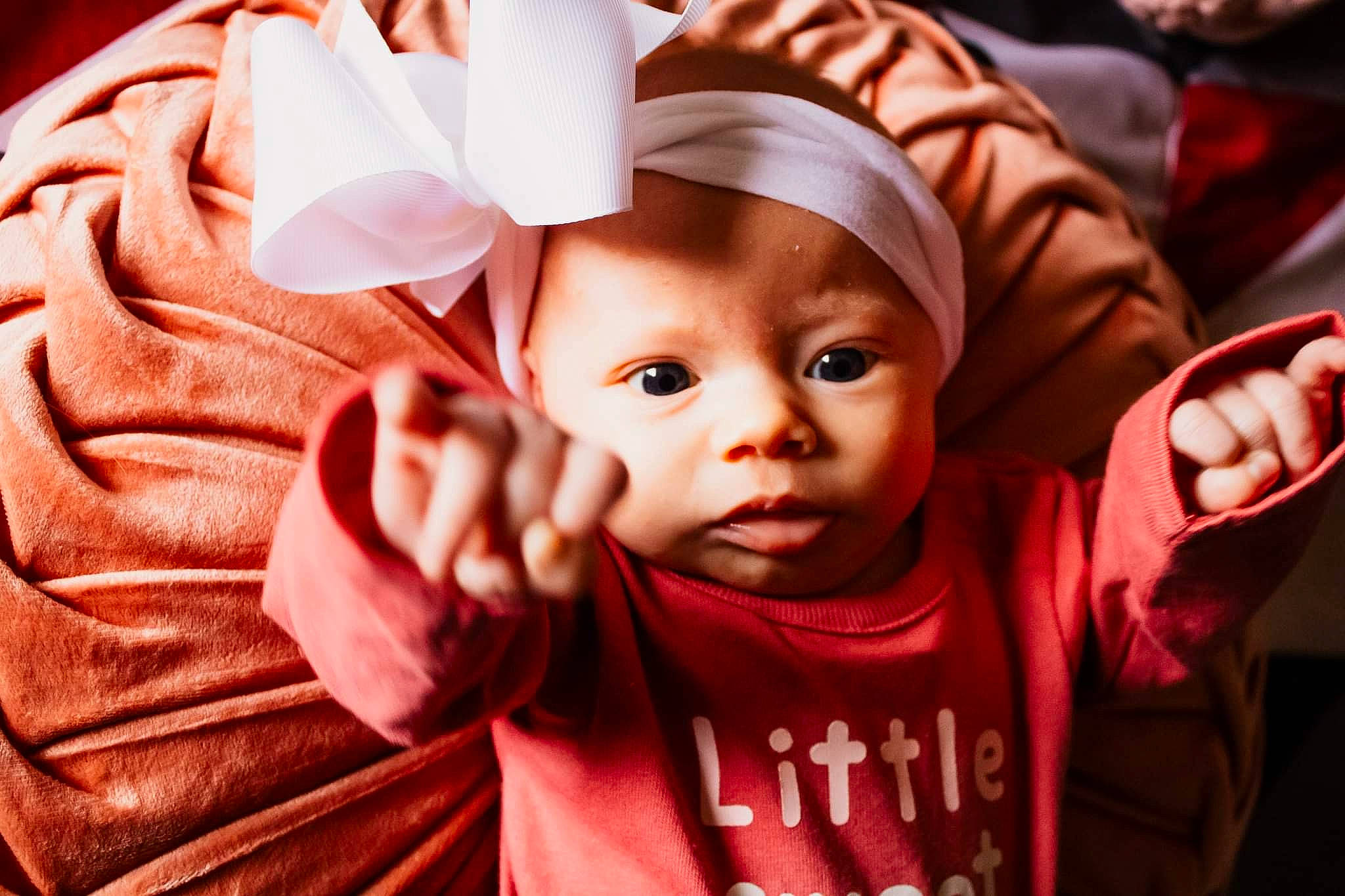 Estella joined the competition — help win amazing prizes! baby, cheek, child, event, eye, finger, fun, gesture, happy, head, headwear, lip, mouth, person, pink, skin, sleeve, smile, thumb, toddler