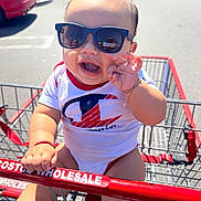 Yarol Cruz joined the competition — help win amazing prizes! baby, child, sunglasses, shopping_cart, costco, outdoor, sunny, smile, happy, toddler, clothing, bracelet, hand, reflection, person, retail, store, casual, shopping, daylight