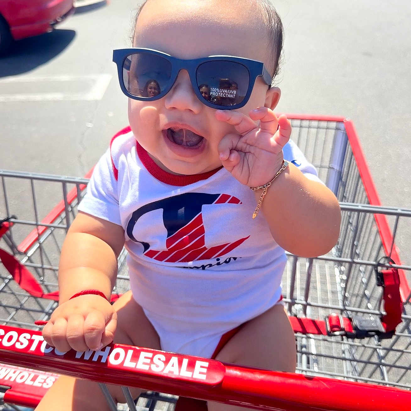 Yarol Cruz joined the competition — help win amazing prizes! baby, child, sunglasses, shopping_cart, costco, outdoor, sunny, smile, happy, toddler, clothing, bracelet, hand, reflection, person, retail, store, casual, shopping, daylight