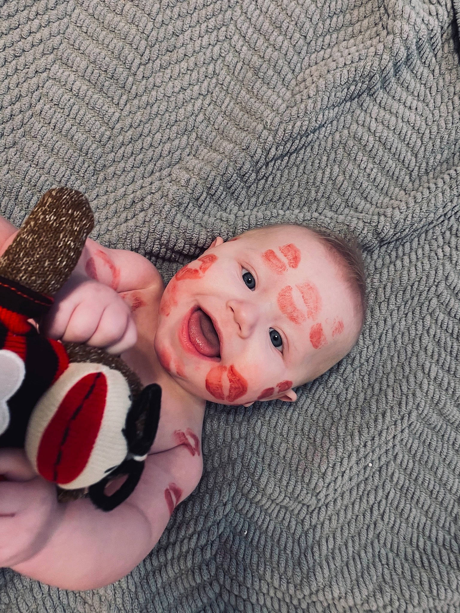 Leighton is registered to the contest to win money with this photo: baby, baby_toddler_clothing, carmine, child, comfort, fashion_accessory, finger, flesh, foot, human_leg, leg, linens, nail, pattern, peach, person, petal, pink, sweetness, textile