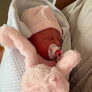 Louélyne participe au concours pour gagner de l'argent avec cette photo : newborn, baby, pacifier, blanket, hat, stuffed_animal, pink, sleeping, cozy, soft, cute, child, infant, indoor, person, comfort, toy, rest, warm, bundle