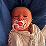 Louélyne a rejoint le concours — aidez-le/la à gagner de superbes lots ! baby, pacifier, blanket, onesie, infant, sleepy, clothing, indoor, child, cute, lying_down, face, hand, comfort, soft, closeup, newborn, rest, bed, warm