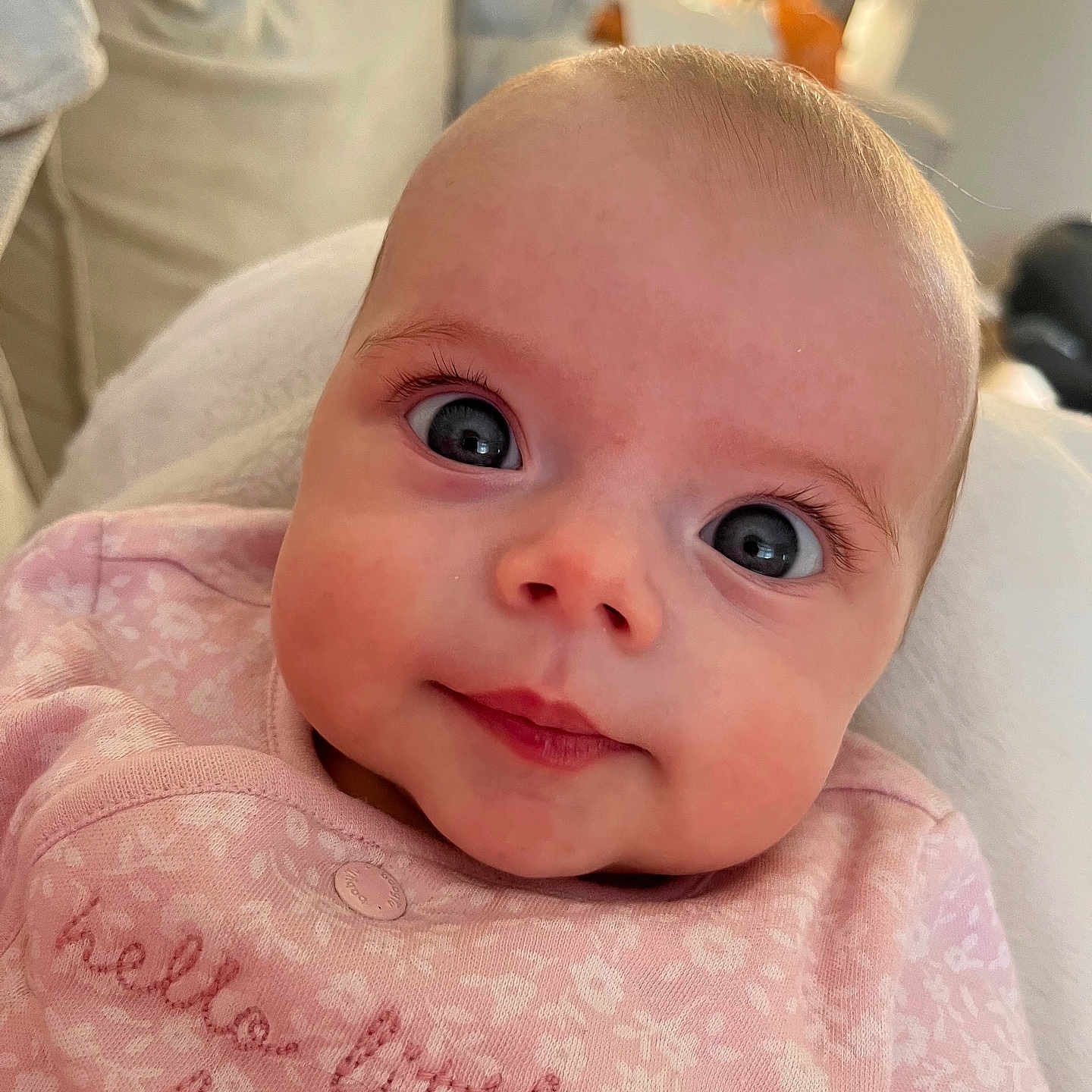 Bella joined the competition — help win amazing prizes! apparel, baby, blanket, child, closeup, cute, expression, eyelashes, eyes, face, head, indoor, infant, newborn, pink_clothing, portrait, skin, smile, soft, young