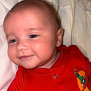 Phillip joined the competition — help win amazing prizes! baby, infant, smile, face, red_clothing, cartoon, blanket, closeup, child, cute, skin, head, eyes, person, happy, indoors, newborn, baby_clothes, portrait, expression