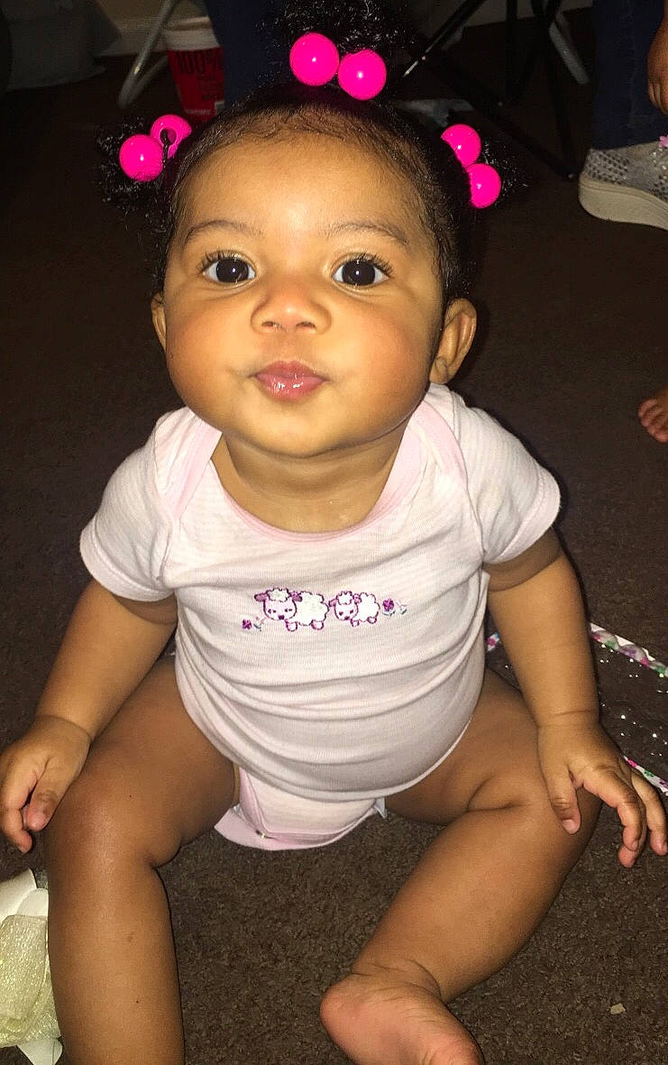 Zay'La is registered to the contest to win money with this photo: arm, baby, baby_toddler_clothing, cheek, child, face, fun, head, leg, neck, person, pink, sitting, skin, smile, toddler