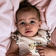 Lainey is registered to the contest to win money with this photo: baby, infant, child, portrait, face, expression, clothing, blanket, pink, cute, person, skin, hand, eyes, hair, sleeveless, fashion, soft, indoor, newborn
