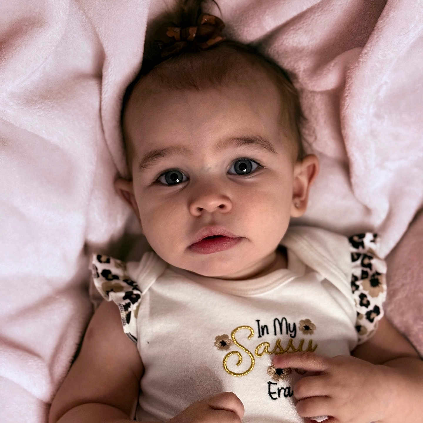 Lainey is registered to the contest to win money with this photo: baby, infant, child, portrait, face, expression, clothing, blanket, pink, cute, person, skin, hand, eyes, hair, sleeveless, fashion, soft, indoor, newborn
