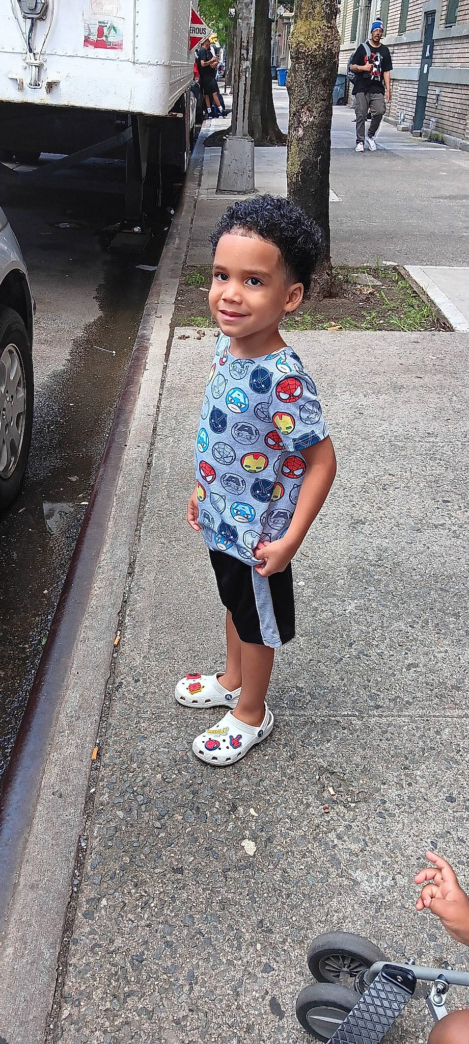 King Azariah joined the competition — help win amazing prizes! asphalt, black, cool, eye, face, hair, hairstyle, happy, head, infrastructure, joy, person, road_surface, shorts, sidewalk, sleeve, standing, style, t_shirt, tire